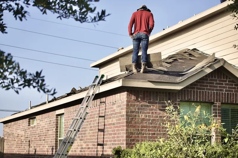 Professional roofer working on a residential roof in Muscatel